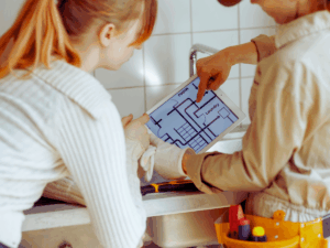 Homeowner going over room addition checklist with remodeler